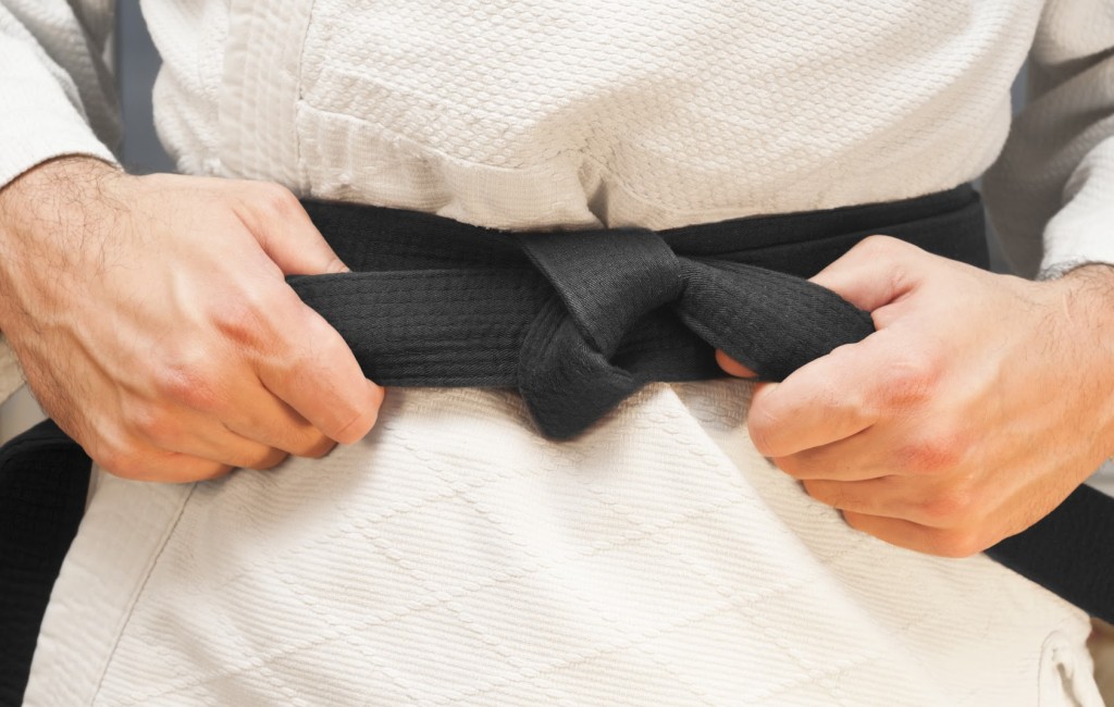 Aikido black belt on white kimono